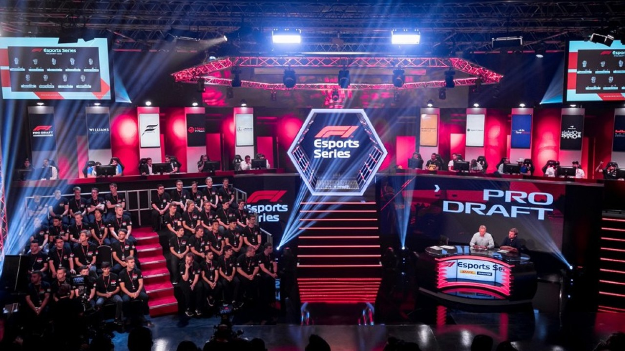 Esports arena with red lighting and an audience facing the camera