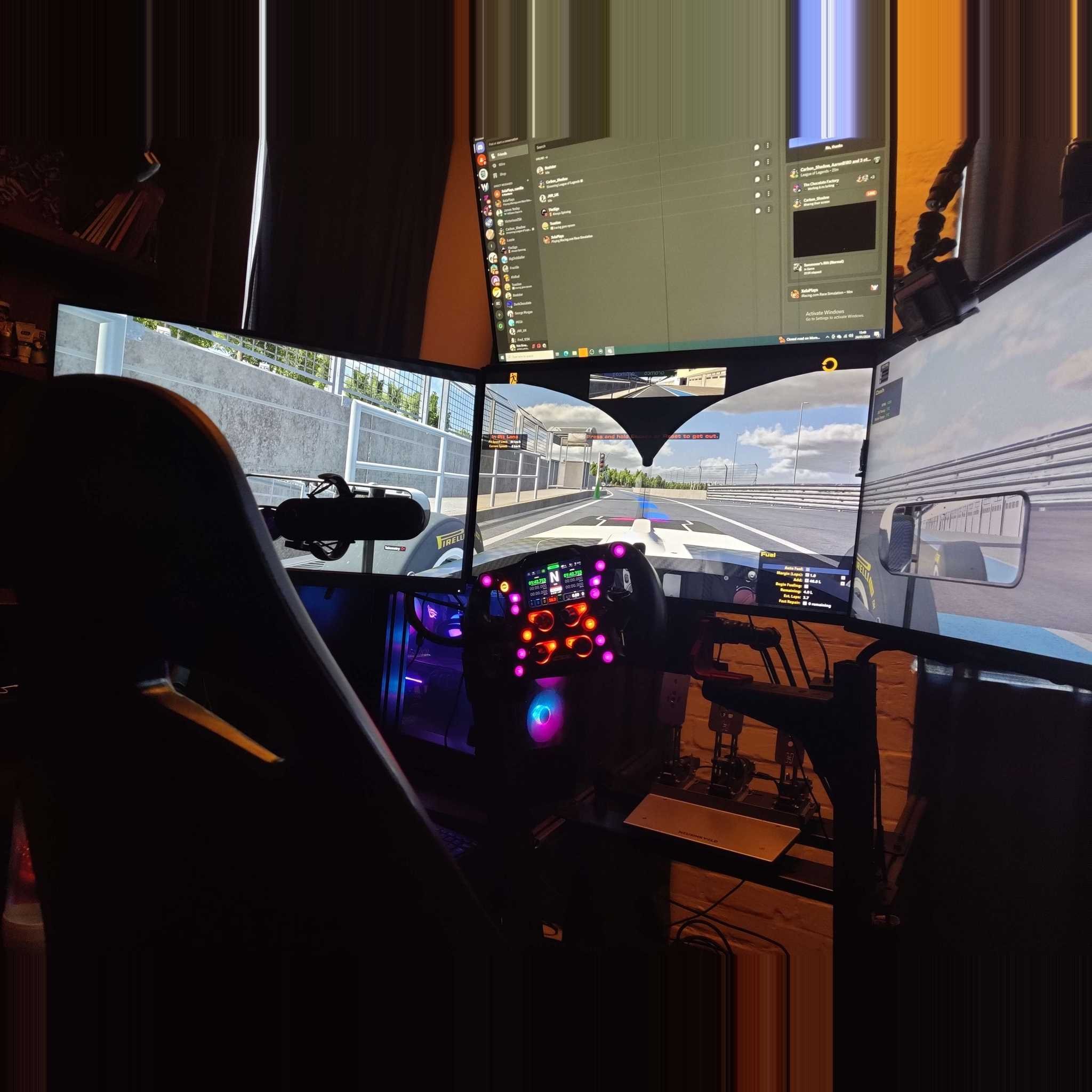 3 screen racing simulator with steering wheel and gaming chair set up