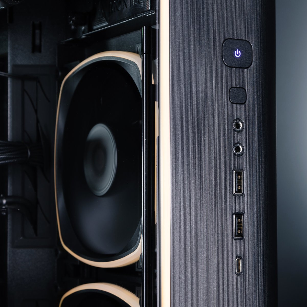 The front I/O panel of the Forge 5090 gaming PC, with a view of the internal fans