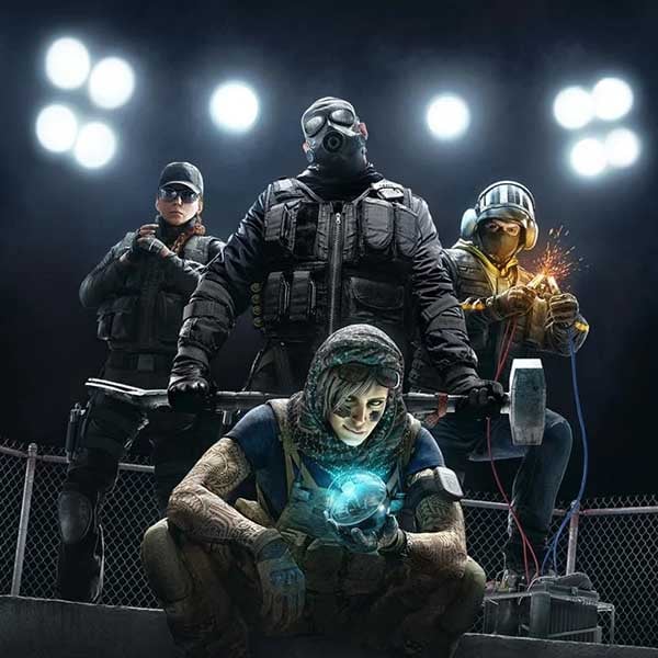 Promotional artwork for Rainbow Six Siege featuring four Operators in tactical gear, with one crouching and holding a glowing gadget while the others stand behind under bright stadium lights.